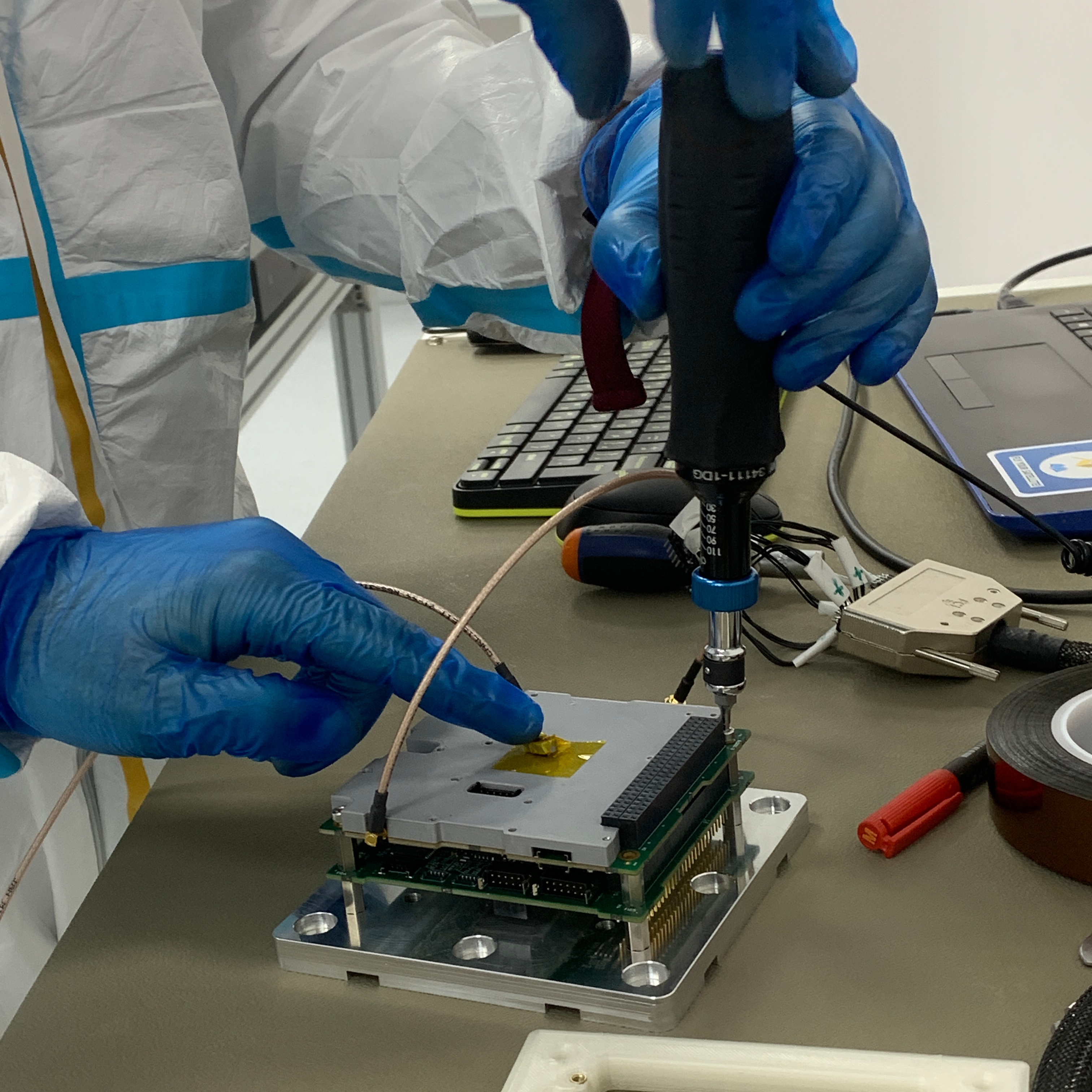 The PCB stack being assembled in a cleanroom